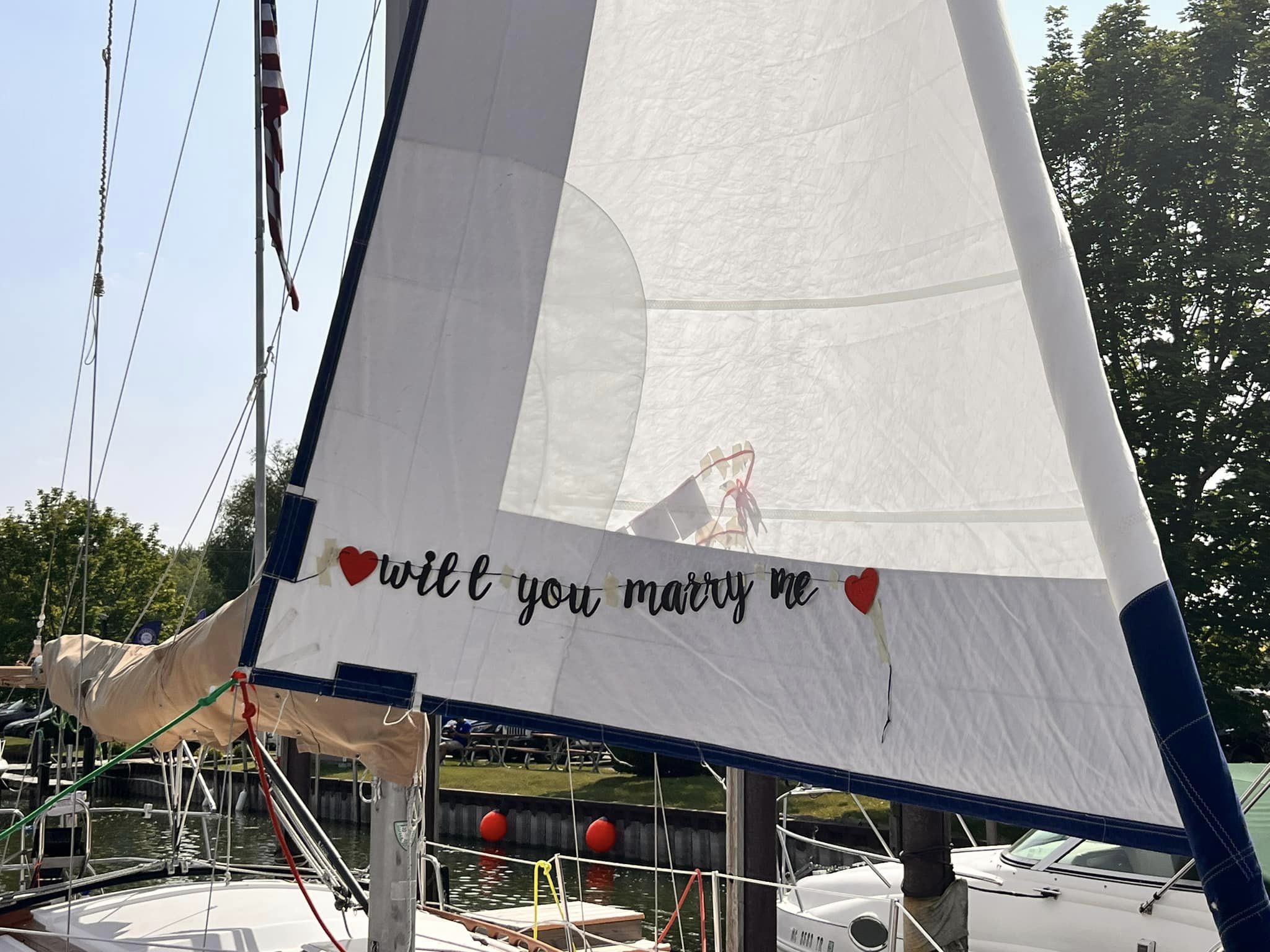 A sail decorated with the words Will you marry me for a Lake St. Clair proposal